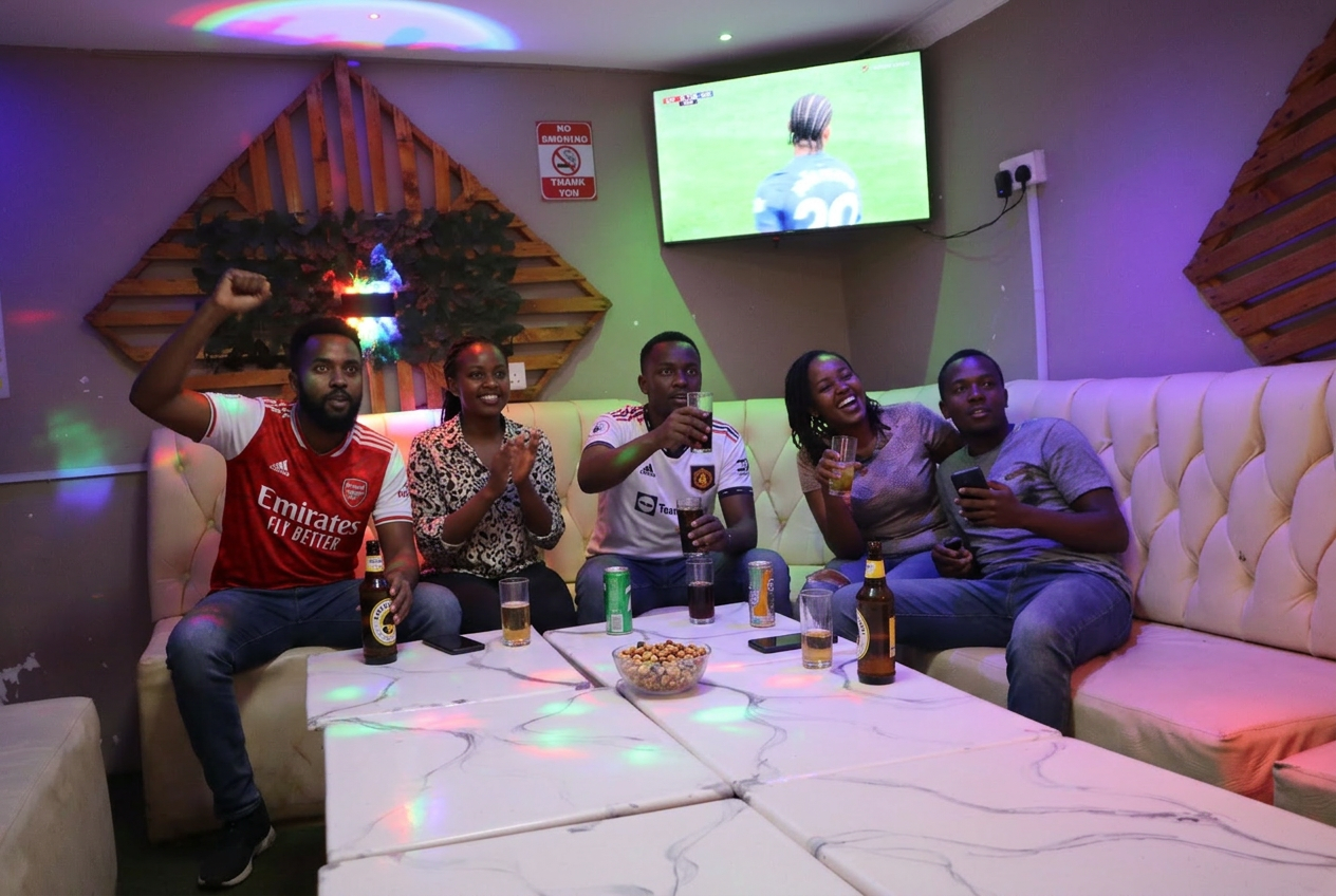 Friends cheering a football match at T&A Lounge in Kimumu, Eldoret